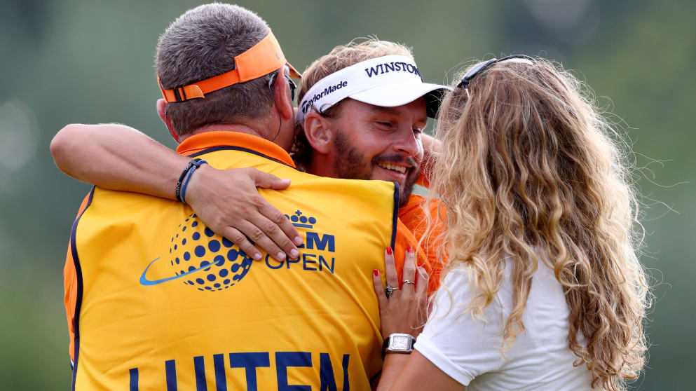 Joost Luiten celebrates his second KLM Open victory with his caddie Mike Waite and Melanie Lancaster