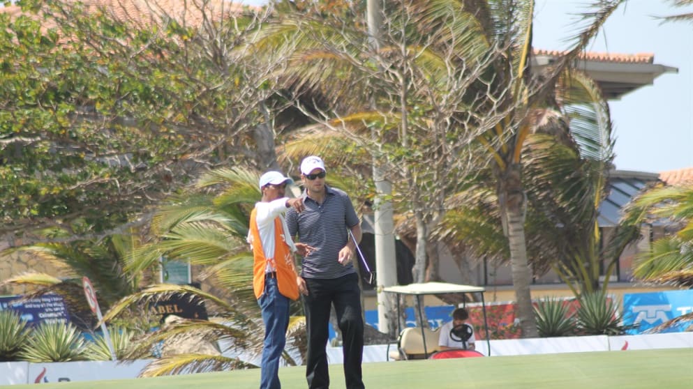 Nick Dougherty discusses a putt with his caddy during round three of the Pacific Rubiales Colombia Classic