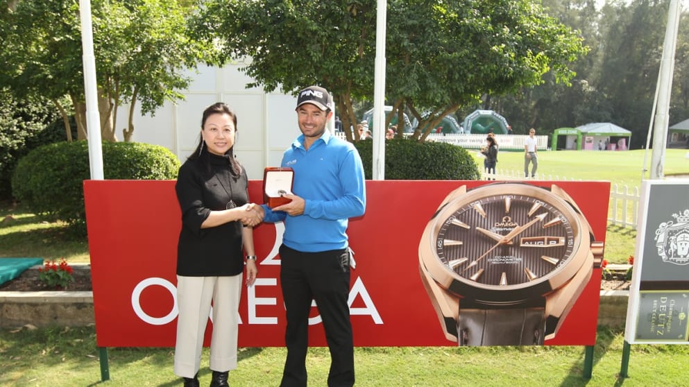 Gareth Maybin receives his Omega Seamaster from Elinda Cheng of Omega.