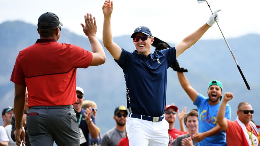 Justin Rose celebrates making a hole-in-one on the fourth