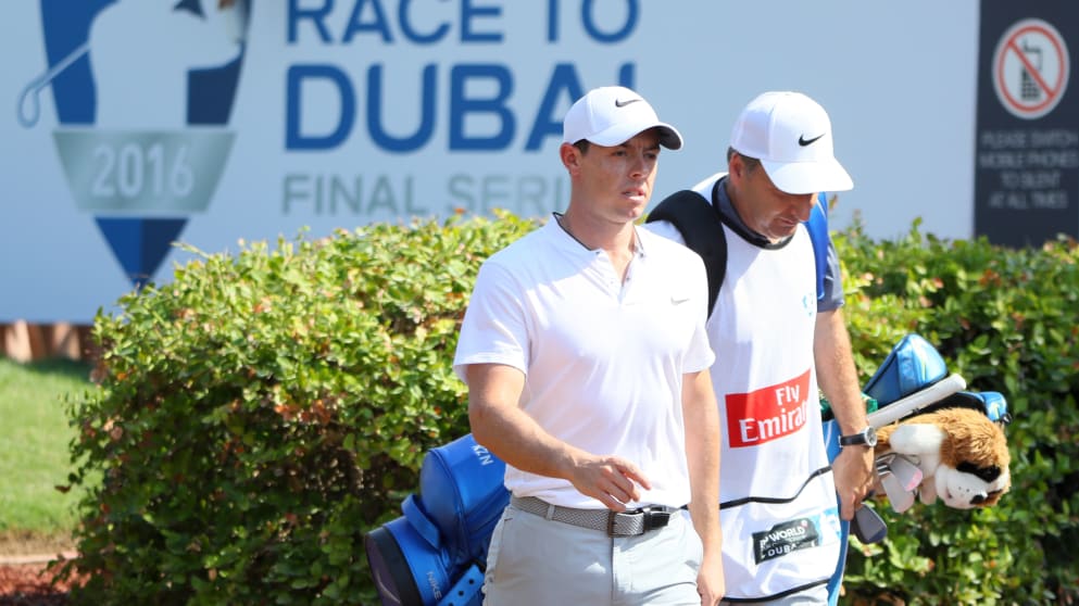 Rory McIlroy - walks off the first tee with caddie JP Fitzgerald during day one of the DP World Tour Championship at Jumeirah Golf Estates 