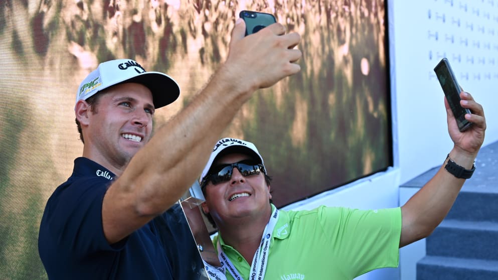 Andrea Pavan and his caddie take selfies after the victory
