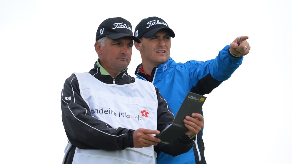 Lloyd Saltman (R) of Scotland talks with his caddy during day one of the Madeira Islands Open