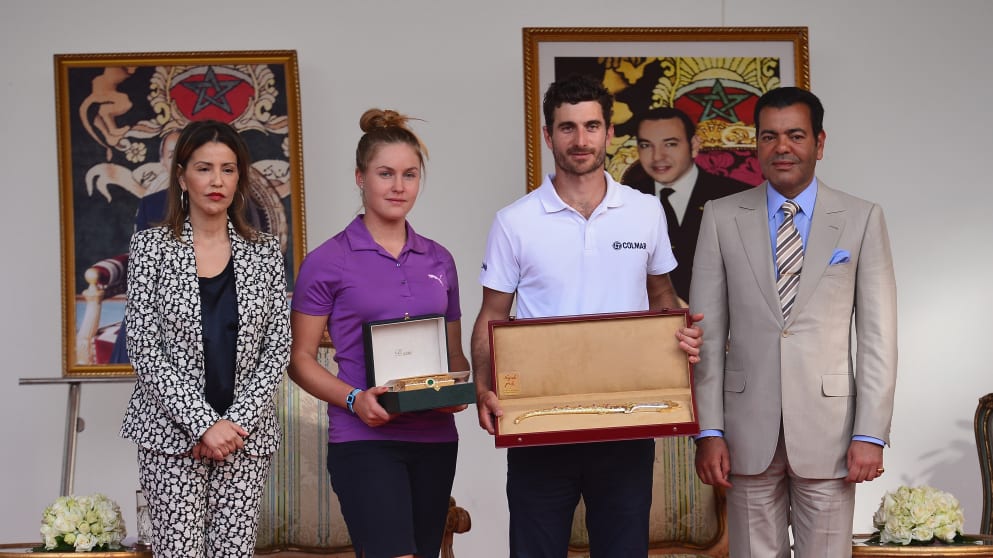 Charley Hull and Alejandro Canizares are presented with their winners trophies by HRH Prince Moulay Rachid and Princess Lalla Meryem after the final round of the Trophee Hassan II Golf.