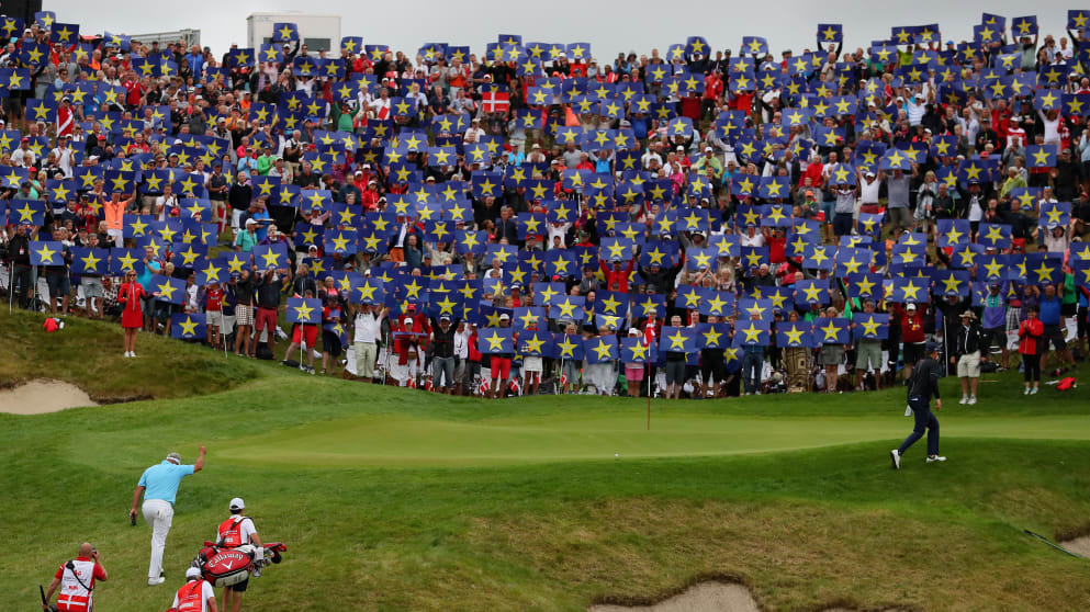 Crowds hold up Go Europe placards for the European Ryder Cup team Captain Darren Clarke on the 16th green