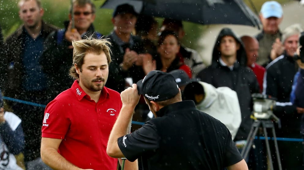 Victor Dubuisson of France shakes hands with Shane Lowry of Ireland