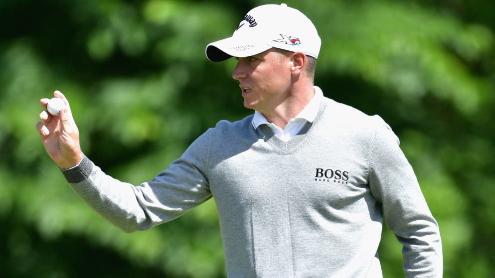 Alex Noren responds to the crowd during his third round