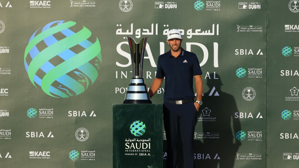 Dustin Johnson celebrates with the trophy