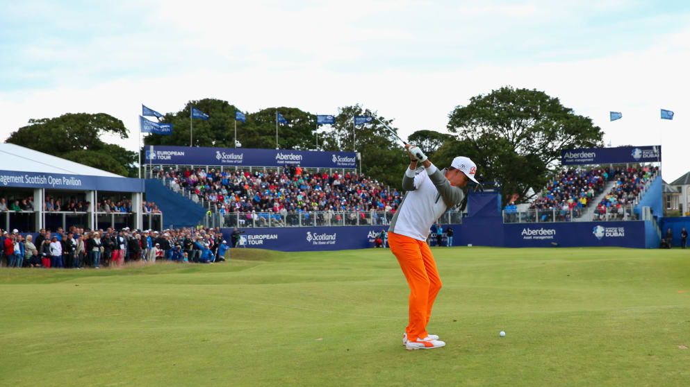 Rickie Fowler hits an approach shot on the 18th hole