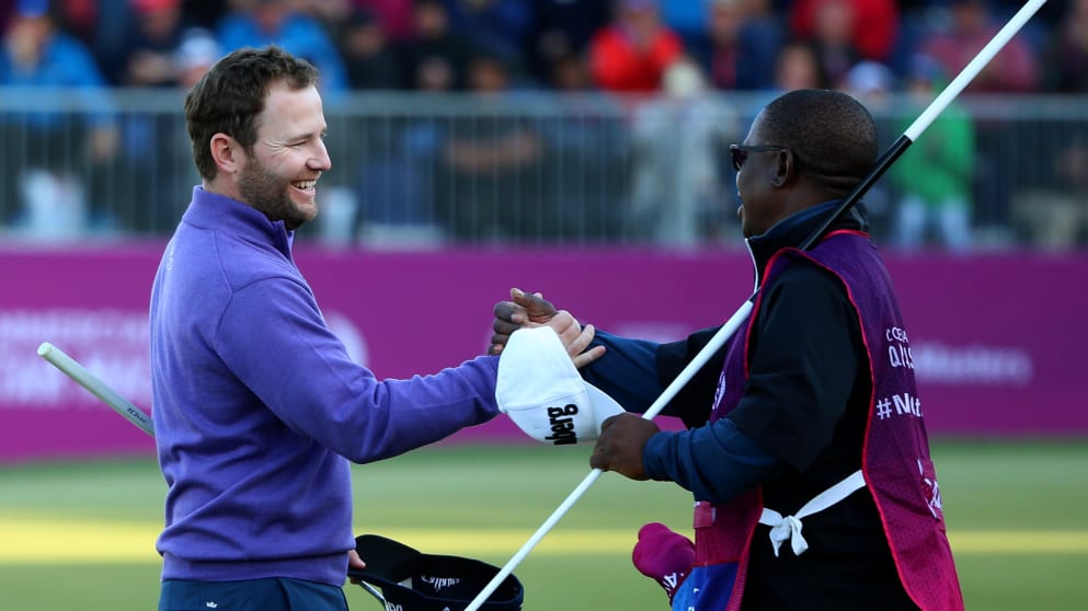 Branden Grace celebrates another Qatar victory with his caddie Zack Rasego on the 18th green