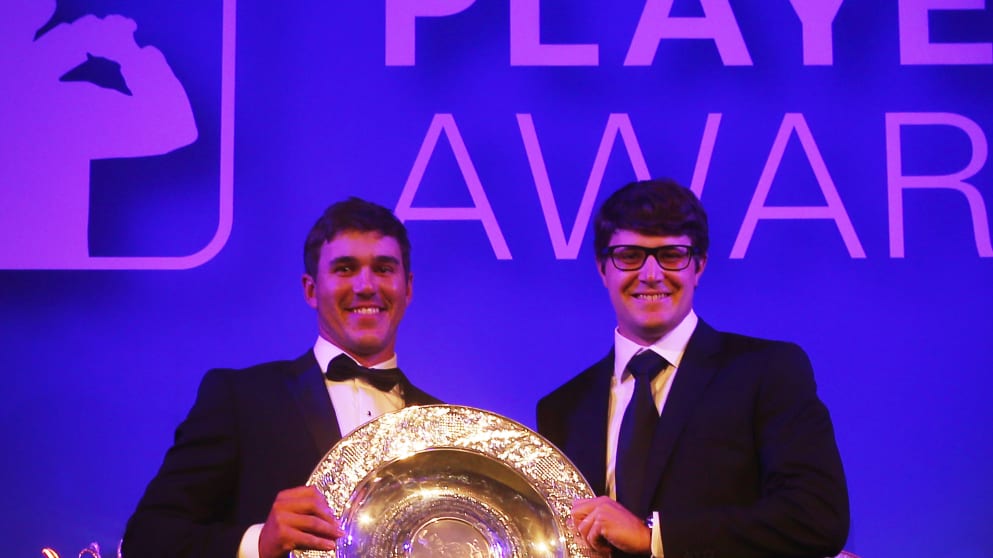 Brooks Koepka (L) receives the Rookie of the Year award from Peter Uihlein during the European Tour Players' Awards
