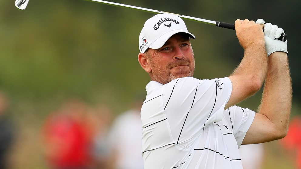 Thomas Bjorn hits his second shot on the 18th hole 