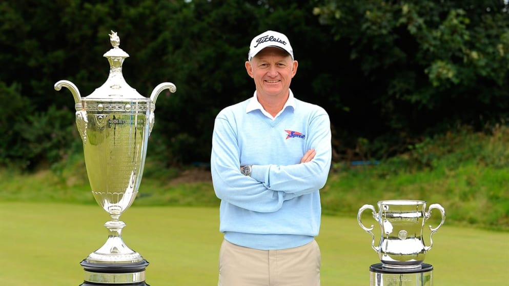 Roger Chapman  poses with the US Senior PGA trophy and the US Senior Open trophy