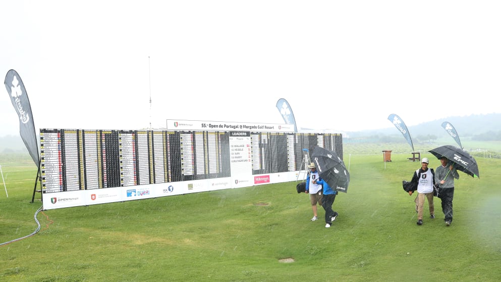 Players walk off the course as play is suspended