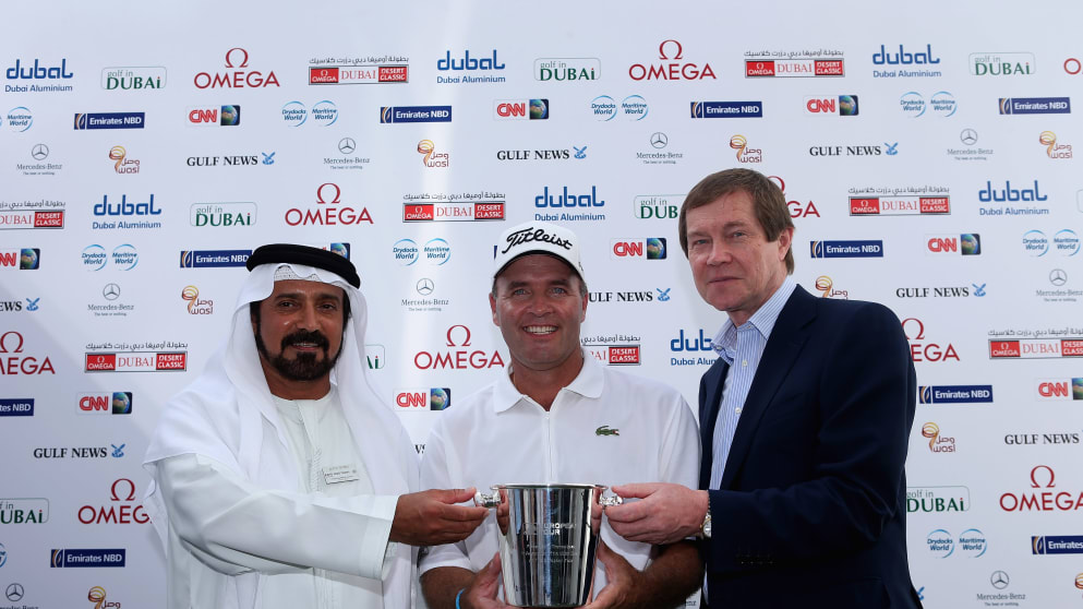 Thomas Levet is presented with a Thomas Lyte silver ice bucket by Mohamed Juma Buamaim, Vice Chairman and CEO of golf in Dubai (left), and George O'Grady, Chief Executive of The European Tour