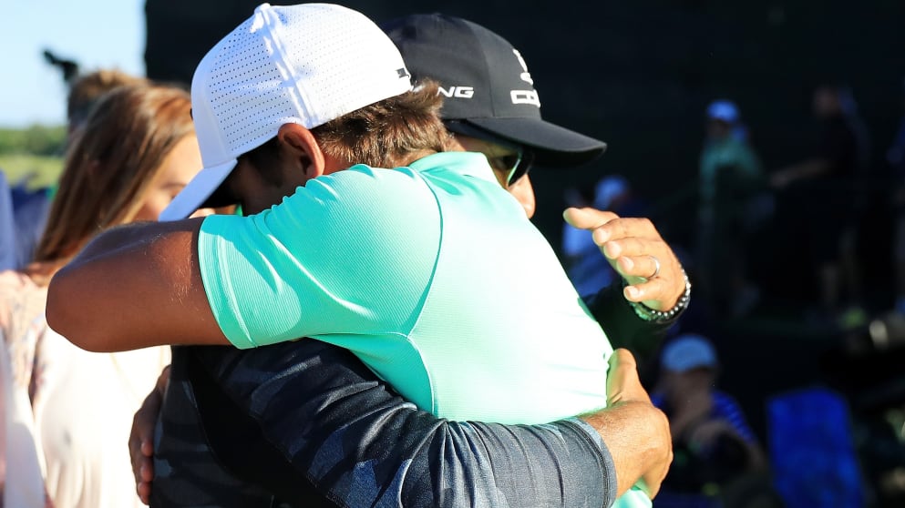 Brooks Koepka hugs coach Claude Harmon at the US Open