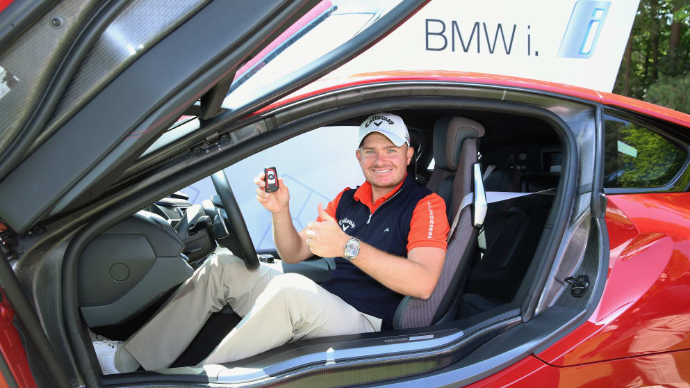 James Morrison sits in his new BMW i8 car after his hole-in-one on the 14th 