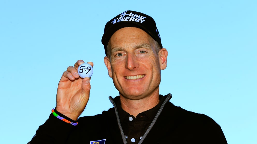 Jim Furyk holds up his ball with a '59' on it 