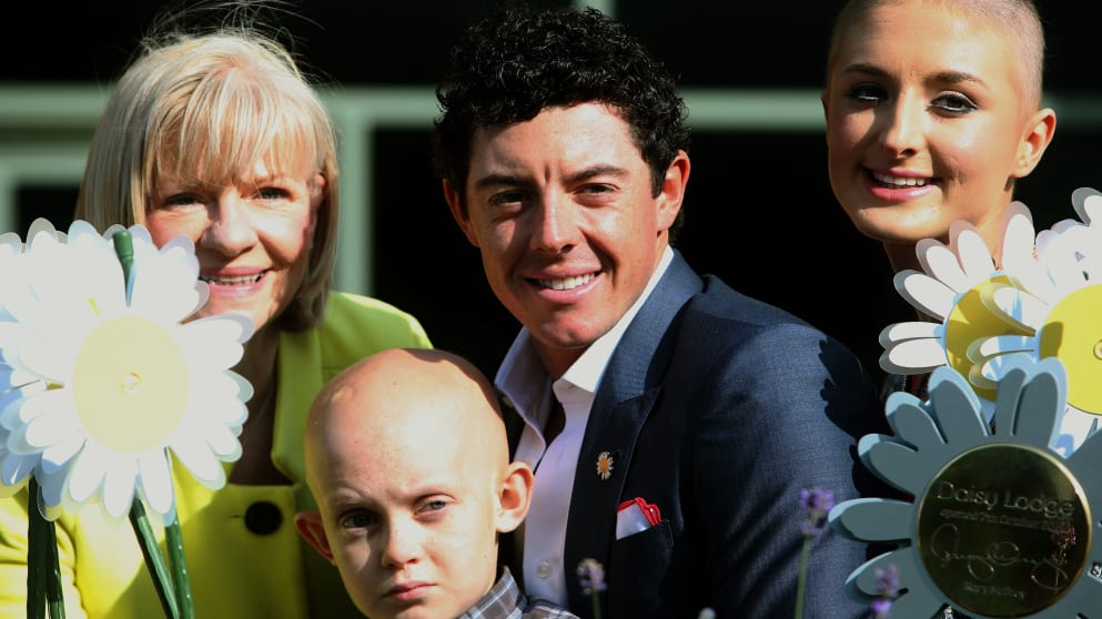 Rory McIlroy with Gillian Creevy, Cancer Fund for Children's Chief Executive (left) Caleb Overton (10) and Amy Uprichard (right)  (Photo credit: Press Association)