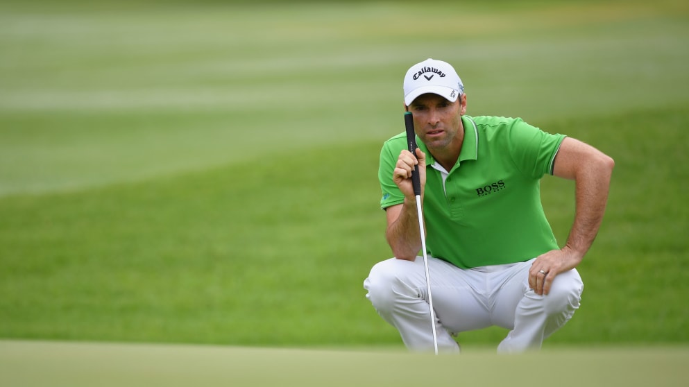 Oliver Wilson of England lines up a putt during the final round 