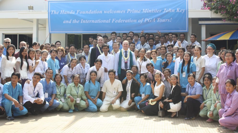 Former New Zealand Prime Minister John Kay with staff at the Handa Medical Center