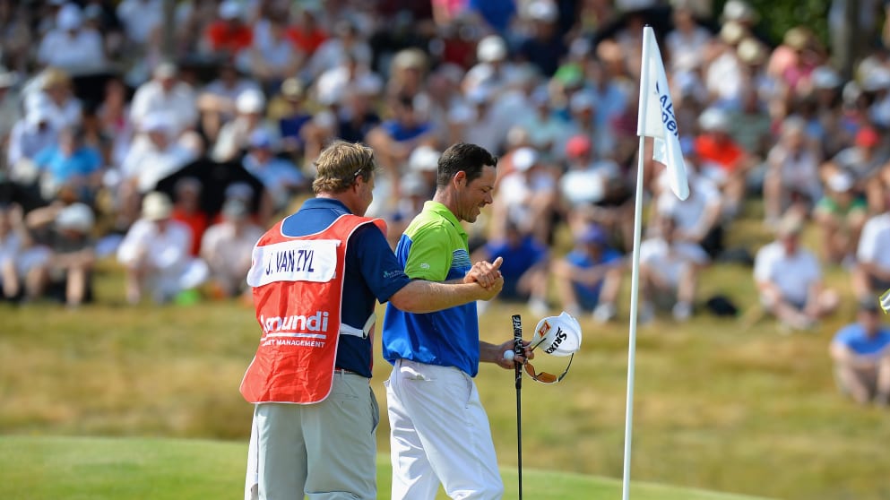 Jaco Van Zyl celebrates with his caddy as he finishes on 10 under par 
