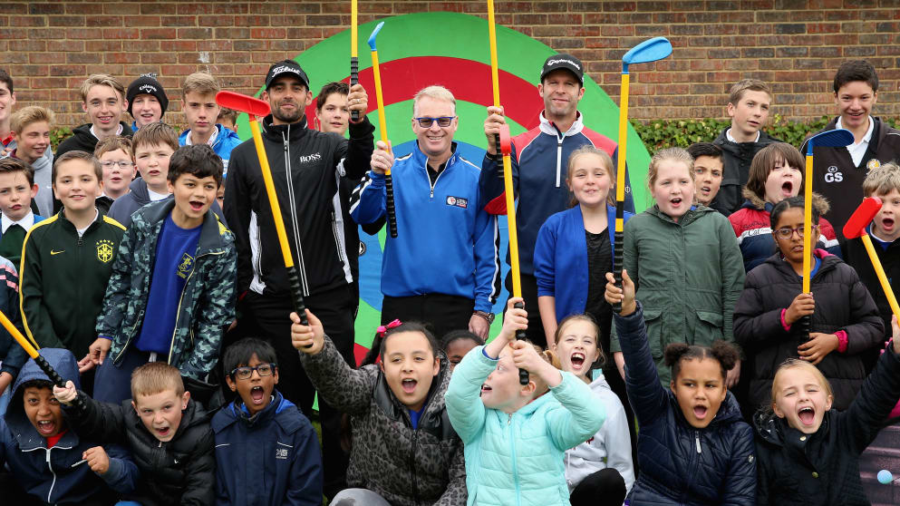 Keith Pelley, Chief Executive of The European Tour, flanked by Lee Slattery (left) and Bradley Dredge  (right) with members of the Golf Foundation's Street Golf initiative at Woburn