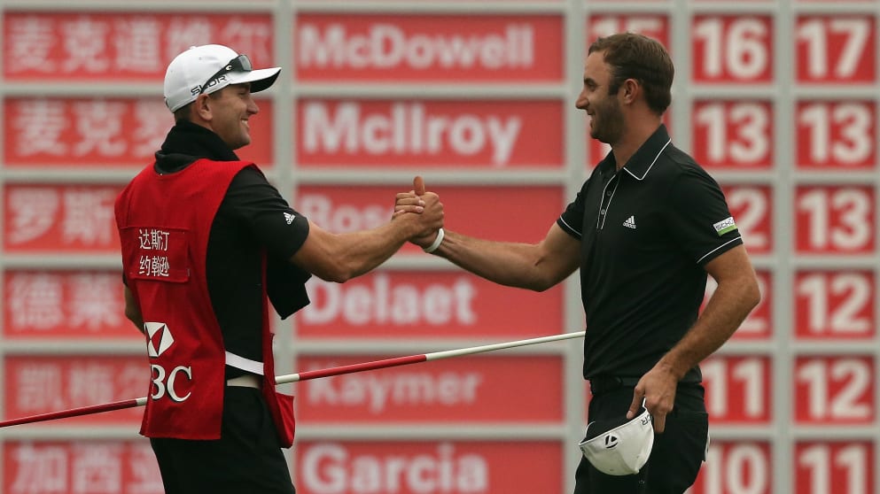 Dustin Johnson celebrates with his brother and caddie Austin Johnson