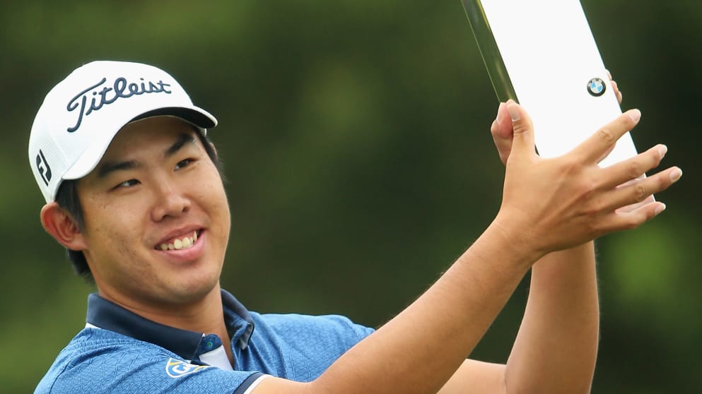 Byeong-Hun An of South Korea holds the trophy aloft following his victory during day 4 of the BMW PGA Championship at Wentworth on May 24, 2015 in Virginia Water, England.