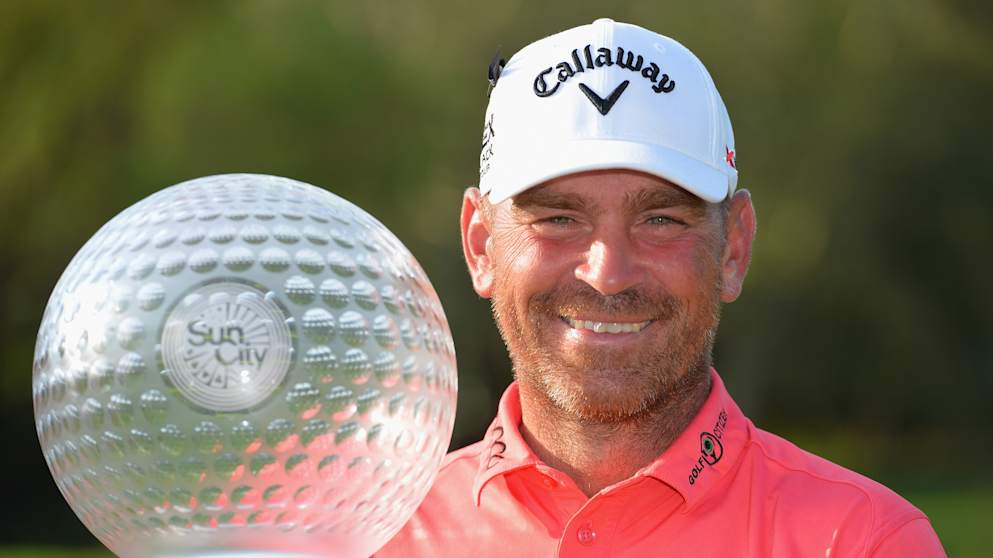 2014 winner Thomas Bjorn poses with the Nedbank Golf Challenge trophy