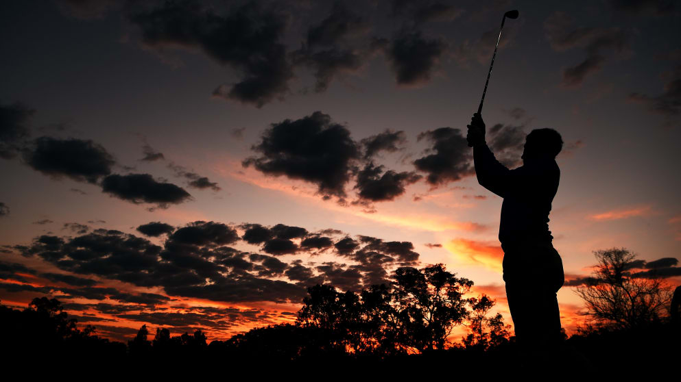 A player hits a shot as he warms up at sunrise before the start of the second round of the Tshwane Open 