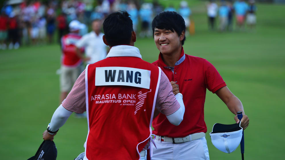 Jeunghun Wang celebrates with his caddie following his victory in Mauritius