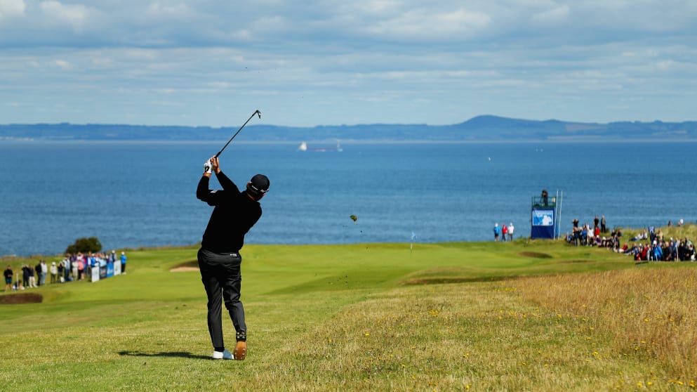 Graeme McDowell of Northern Ireland hits an approach shot on the tenth hole