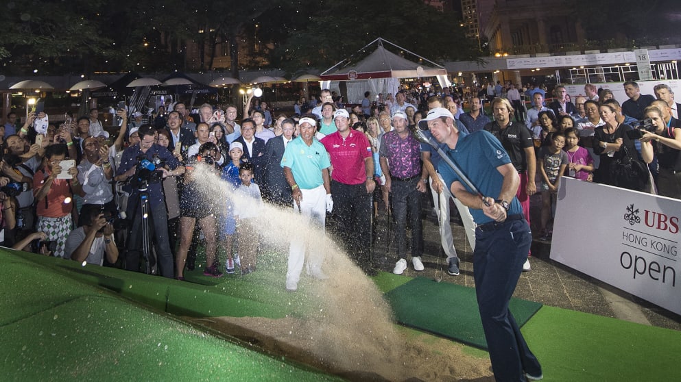 Justin Rose hits a bunker shot in downtown Hong Kong