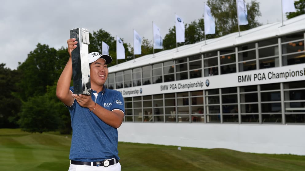 Byeong-Hun An holds the trophy aloft