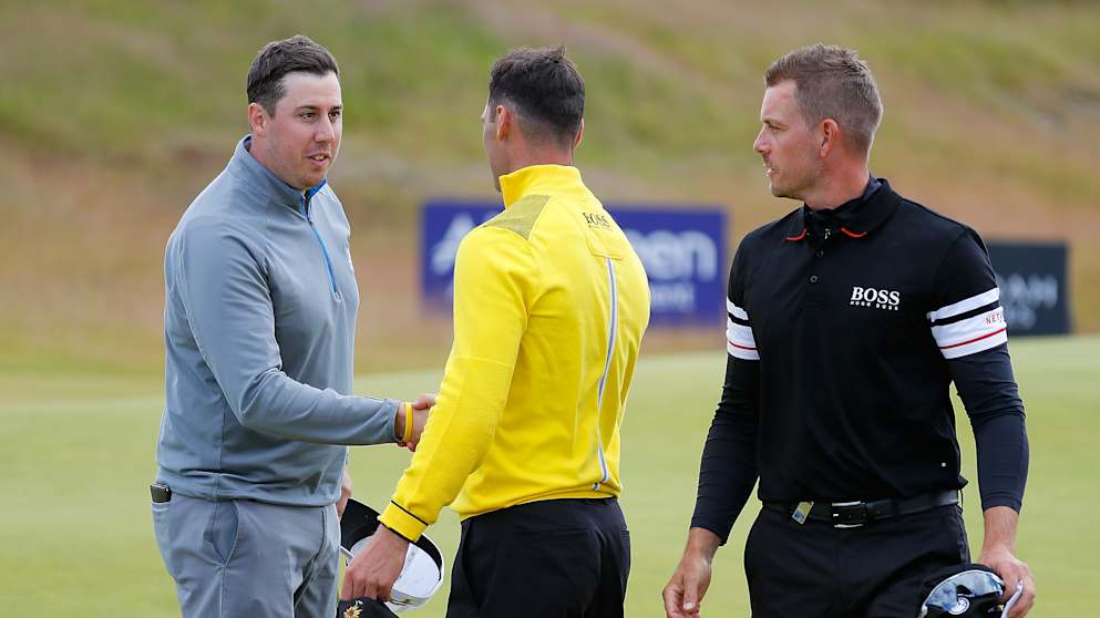 Henrik Stenson of Sweden, Ryan Evans of England and Martin Kaymer of Germany shake hands on the 9th green