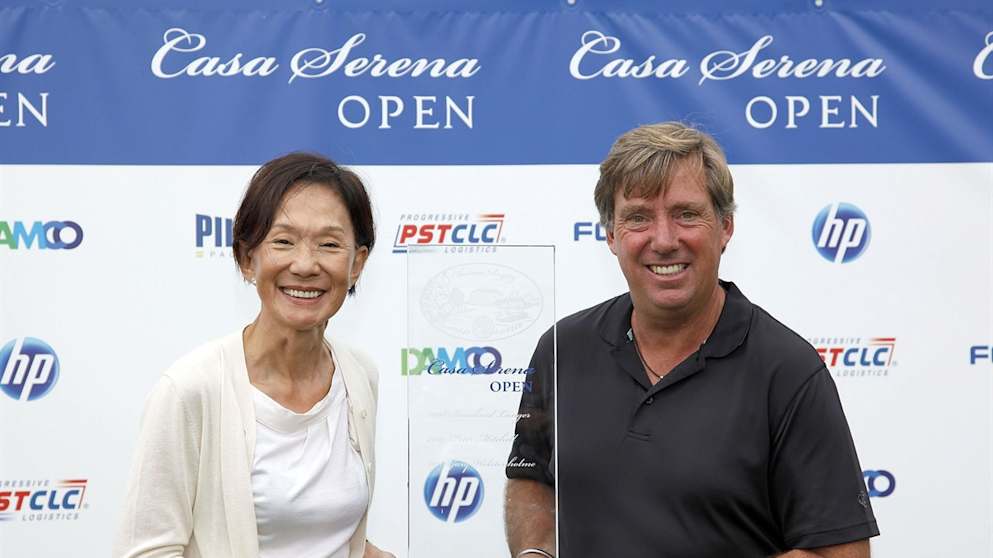   Barry Lane is presented with the Casa Serena Open trophy by Maureen Chang, Founder of Casa Serena Golf 
