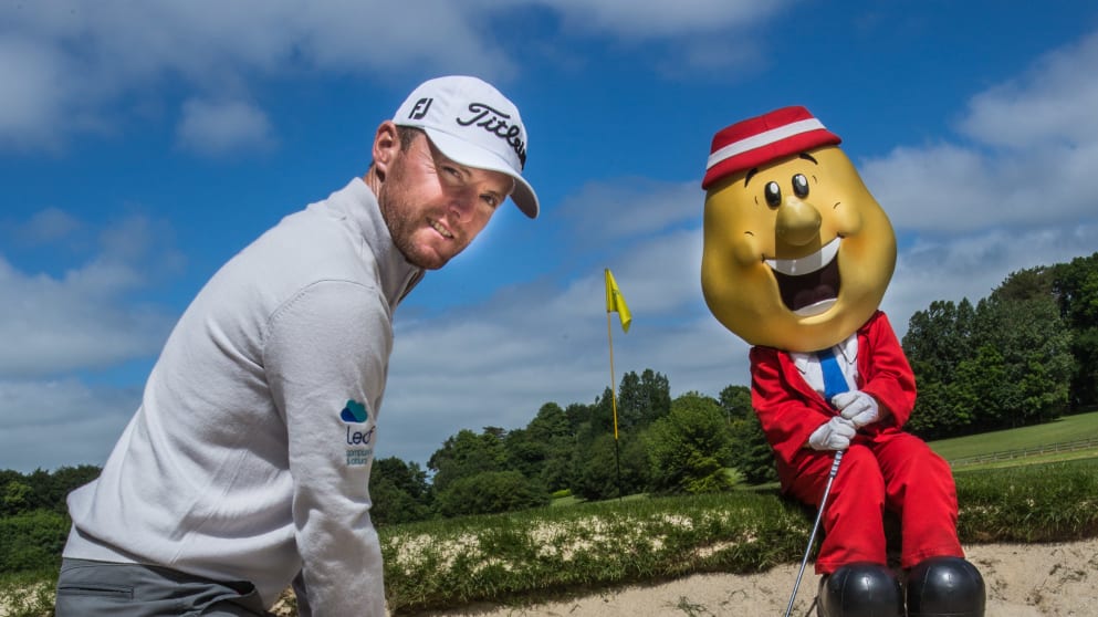 Mr Tayto keeps an eye on Tournament Ambassador Michael Hoey’s bunker play