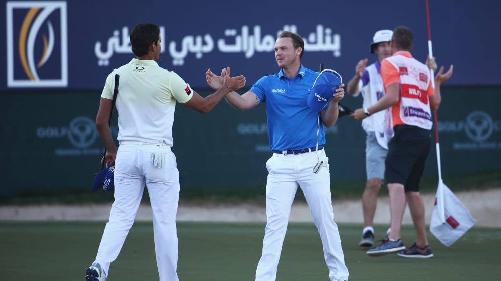 Danny Willett shakes hands with Rafa Cabrera-Bello on the 18th green in the final round of the Omega Dubai Desert Classic