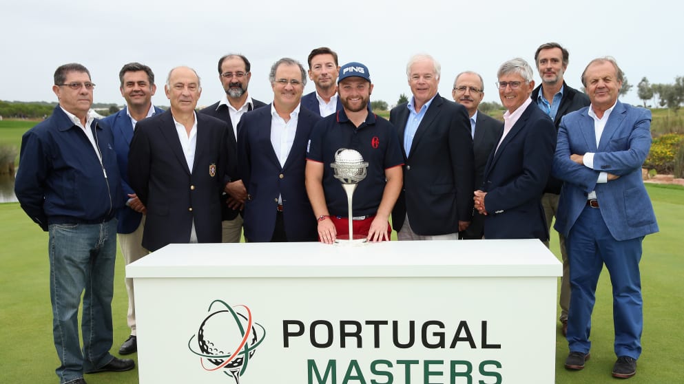 Andy Sullivan of England poses with the trophy alongside tournament dignitaries after winning the Portugal Masters