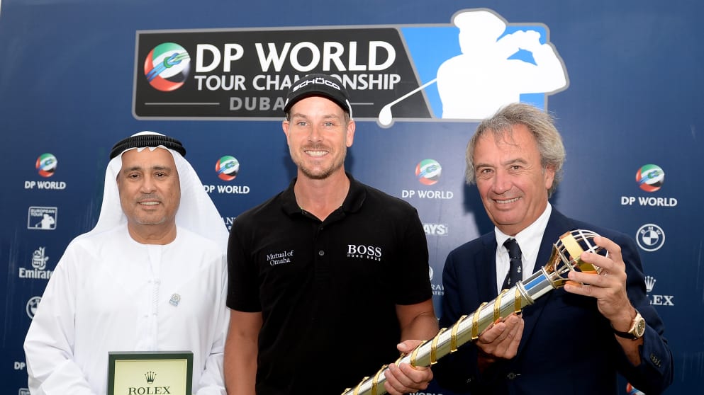 Henrik Stenson is presented with a Rolex watch after winning the DP World Championship 
