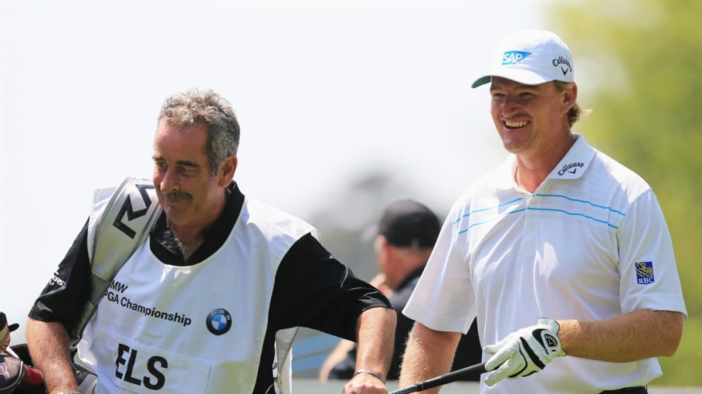 Sam Torrance caddying for Ernie Els