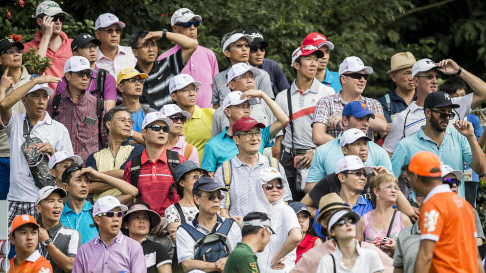 Spectators watch the action on the fouth green during the first round of the UBS Hong Kong Open at the Hong Kong Golf Club