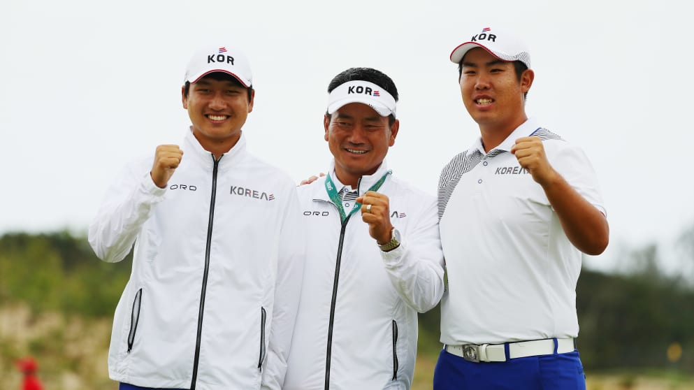Team leader of South Korea K.J. Choi poses with his players Jeung-hun Wang and Byeong-hun An