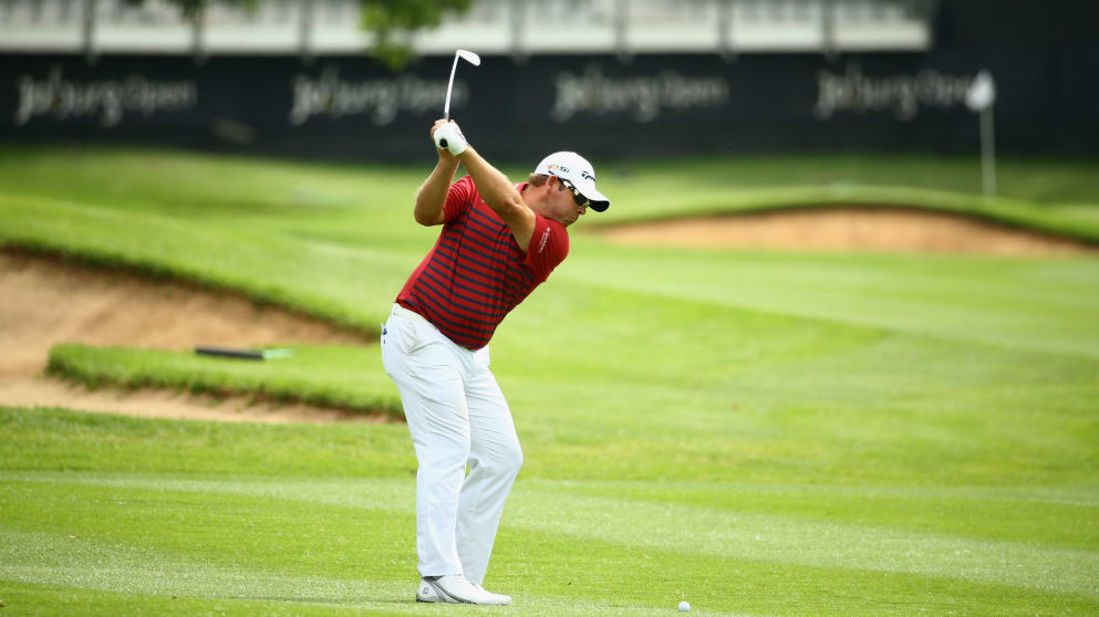 Justin Walters of South Africa plays his second shot towards the 18th green