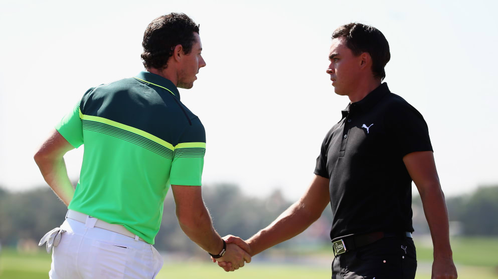 Rory McIlroy and Rickie Fowler shake hands after the first round of the Abu Dhabi HSBC Golf Championship