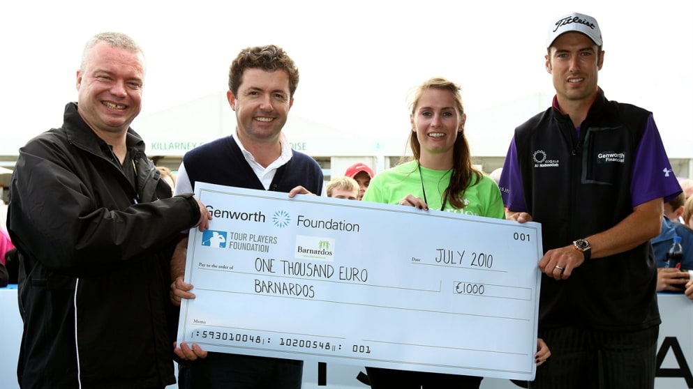  Ross Fisher  and TV commentator Shane O'Donoghue present a cheque to Barnardos