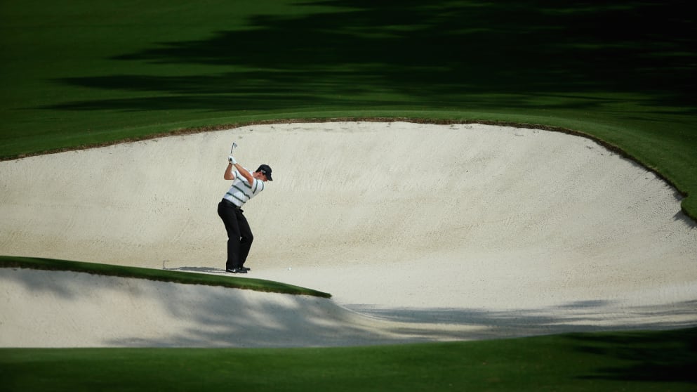 Rory McIlroy hits his second shot from a bunker during Masters practice