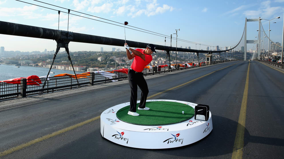 Tiger Woods hits the first golf shots from East to West on Istanbul's iconic Bosphorous Bridge linking Asia and Europe