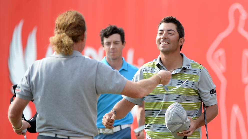 Pablo Larrazabal is congratulated by Miguel Angel Jimenez at Abu Dhabi Golf Club